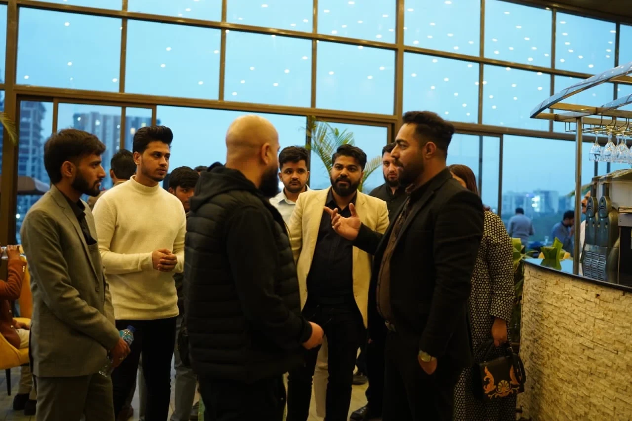 WeProms colleagues talking together beside large windows at a team gathering